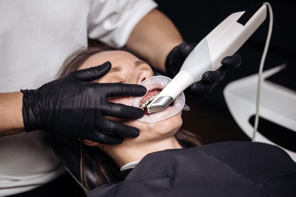 Dentist using an intraoral scanner to capture a digital 3D image of a patient's teeth during a dental examination.