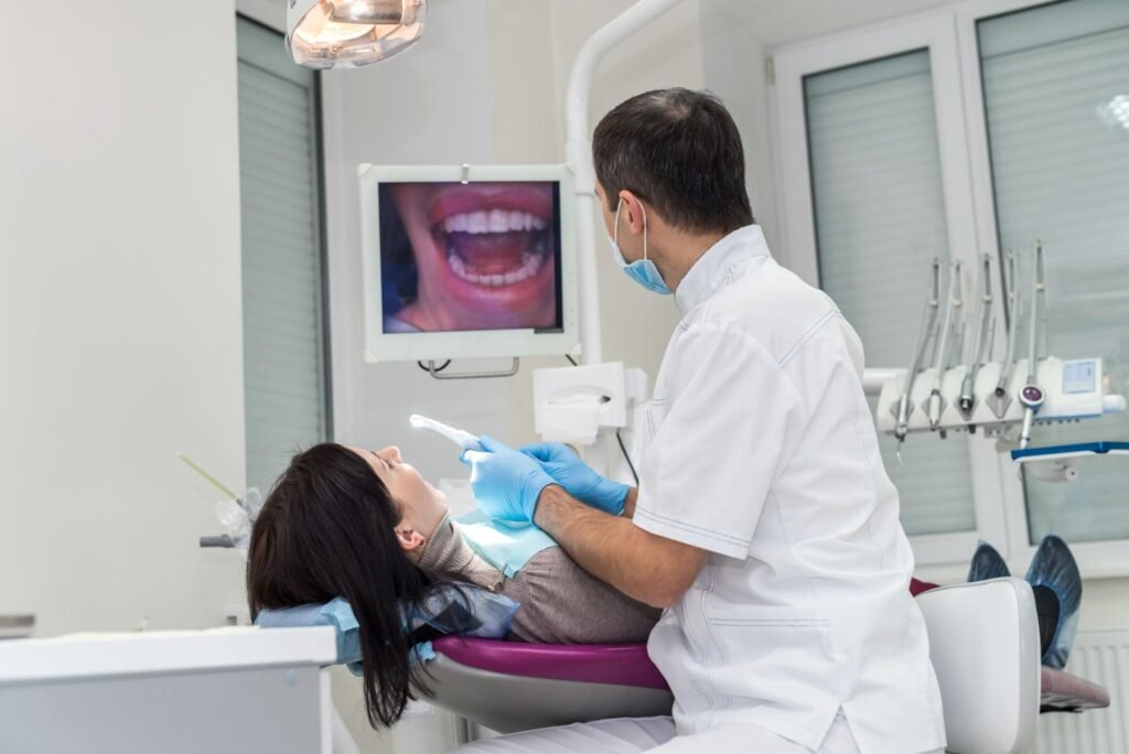Dentist discussing digital orthodontic findings with a patient during a routine dental consultation.
