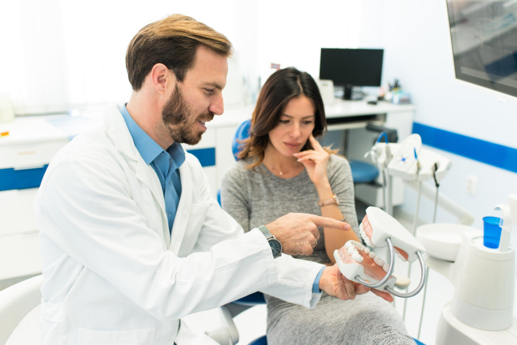 Dental professional discussing crooked teeth with a patient